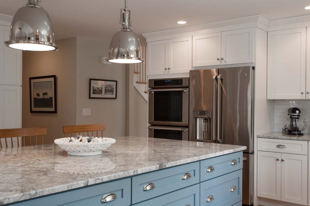 Polished light pendants over super white granite topped island